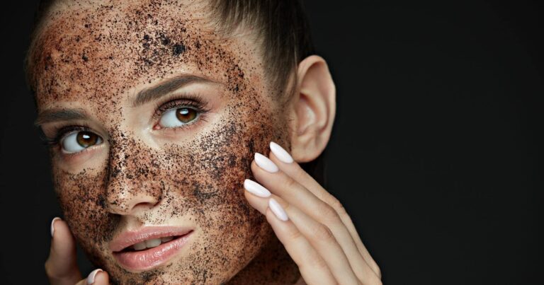 Woman with exfoliating coffee scrub on facial skin