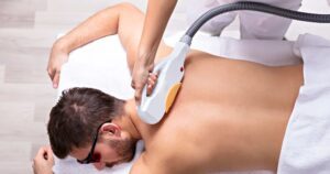 Person receiving laser treatment on their back in a spa setting