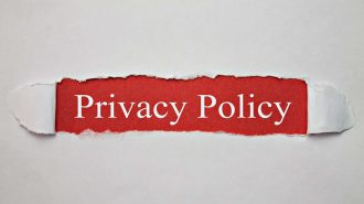 Torn paper revealing the text 'Privacy Policy' on a red background