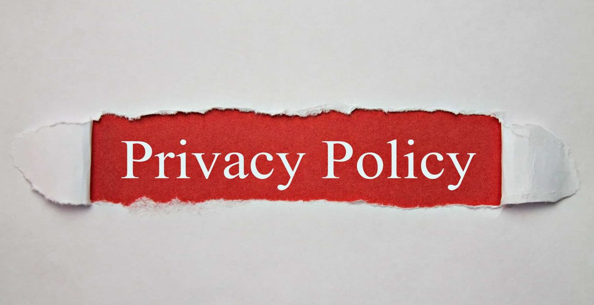 Torn paper revealing the text 'Privacy Policy' on a red background