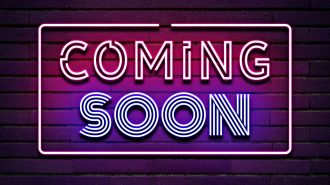 Coming Soon neon sign on dark brick wall background