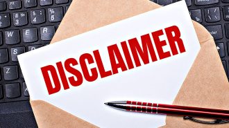 Disclaimer notice on keyboard with red pen