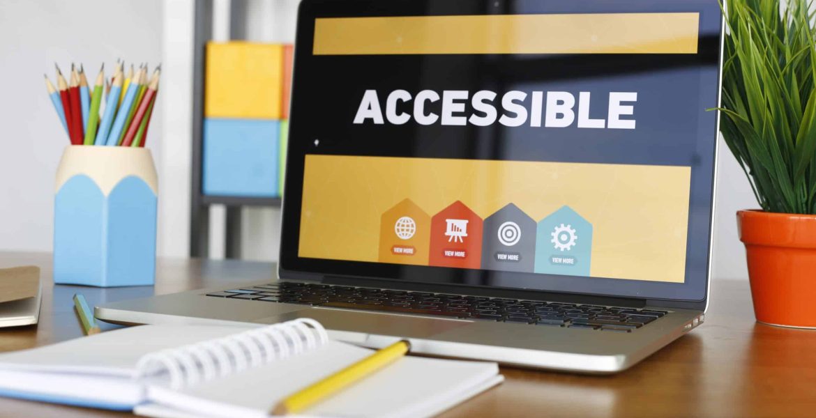 Laptop screen displaying accessibility features concept on a workspace